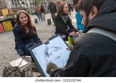 Paris, France - February 27 2007 : Caricature Artist Sketching A Girl Face In Paris, Street Artist