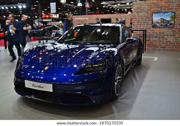 Paris, France - February 4th 2020 :\
Retromobile 2020. Focus on a blue Porsche taycan turbo. This model\
is the first one of Porsche to be 100%\
electric.