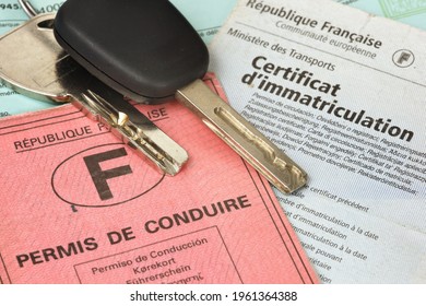 Paris, France - February 6, 2012: Car keys with driver's license, registration certificate and green insurance card. Official document of the French Republic