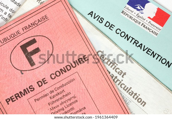 Paris, France - February 6, 2012:\
Driver\'s license with registration certificate and traffic\
violation notice. Official document of the French\
Republic