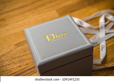 PARIS, FRANCE - JAN 2, 2018: Christian Dior Haute Couture Jewelry Box With Silk Band On A Wooden Table After Unboxing Of The Present 