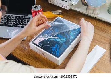 Paris, France - Jan 27, 2019: Woman Unboxing Unpacking New Latest IPad Pro Tablet Computer By Apple Computers - Creative Room Table