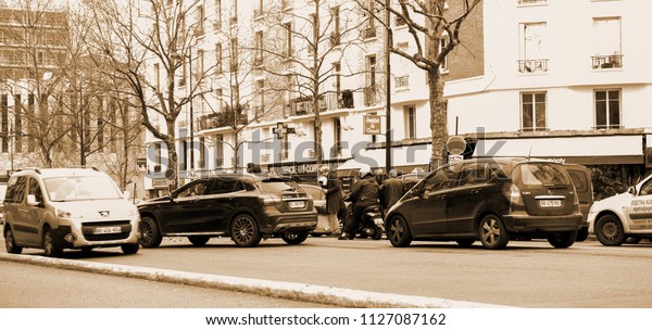 PARIS,\
FRANCE - JAN 30, 2018: Car accident scene on Paris street between\
luxury limousine Lancia Thesis and scooter moped transporting\
medical transfusion blood - rue de\
Courcelles