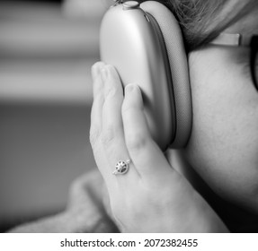 Paris, France - Jan 7, 2020: Musicophile Woman Enjoys Listening New Apple Computers AirPods Max Over-ear Headphones With Adaptive EQ, Active Noise Cancellation, Transparency Mode H1 Chips And Siri