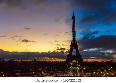Paris, France - January 17, 2019: Night to Day transition over Eiffel tower in winter from Trocadero on a cloudy day - Paris, France.