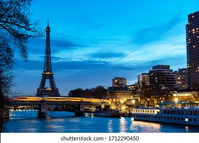 Paris, France - January 17, 2019: Train traffic at dawn on Rouelle Bridge with Eiffel Tower in background - Paris, France.