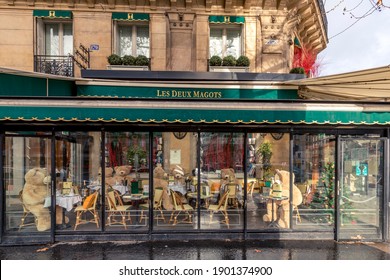 Paris, France - January 23, 2021: Restaurant brasserie on Boulevard Saint Germain is closed due to epidemic of coronavirus COVID19 in Paris. Empty bar, chairs raised, no guests