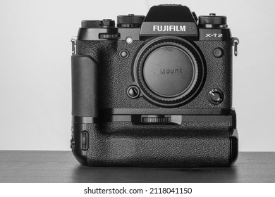 Paris, France - January 29, 2022 : View Of The Mirrorless Fuji Film Aps-c Camera With A Battery Grip On In Black And White 