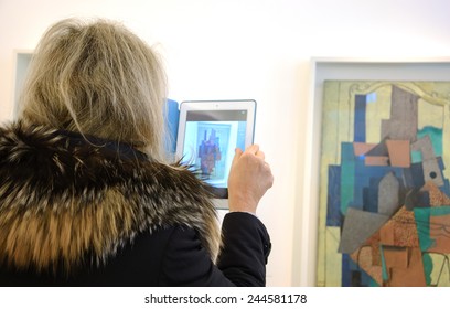 PARIS, FRANCE - JANUARY 4, 2015: Visitor Taking Photo Of Paintings In Picasso Museum. This Biggest Collection Of Works By Pablo Picasso In The World Was Reopened To The Public In 2014.