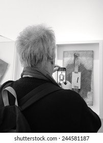 PARIS, FRANCE - JANUARY 4, 2015: Visitor Taking Photo Of Paintings In Picasso Museum. This Biggest Collection Of Works By Pablo Picasso In The World Was Reopened To The Public In 2014. Black White.