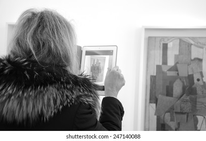 PARIS, FRANCE - JANUARY 4, 2015: Visitor Taking Photo Of Paintings In Picasso Museum. This Biggest Collection Of Works By Pablo Picasso In The World Was Reopened To The Public In 2014. Black White.