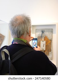 PARIS, FRANCE - JANUARY 4, 2015: Visitor Taking Photo Of Paintings In Picasso Museum. This Biggest Collection Of Works By Pablo Picasso In The World Was Reopened To The Public In 2014.