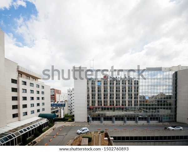 Paris, France - Jul 14, 2011: View from above of\
Ibis Hotel courtyard in central Paris with French renault car\
driving on the road