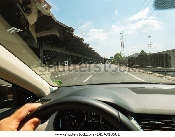 Paris, France -\
Jul 15, 2018: Driver POV personal perspective and the front driving\
Volvo V70 car in traffic jam exiting the tunnel of Boulevard\
peripherique in Paris,\
France