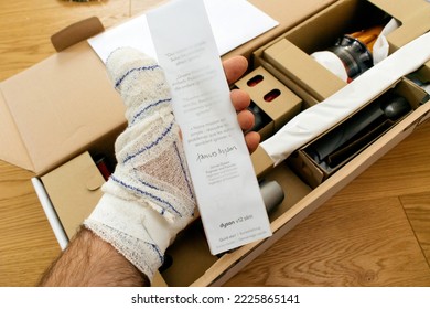 Paris, France - Jul 4, 2022: Man Hand Holding During Unboxing Quick Start Guide Signed By James Dyson Engineer And Founder - Modern Wireless Dyson V12 Detect Slim Absolute Vacuum Cleaner Powerful