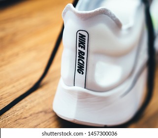 Paris, France - Jul 8, 2019: Macro rear view of new Nike Zoom Fly SP Fast running shoes on wooden table - includes the Nike Racing logotype insignia