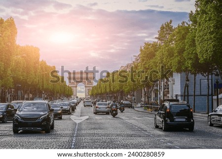 Paris, France July 1, 2022. The Champs Elysees are the most famous avenue in the city. Very busy, the Arc de Triomphe is unmistakable in the background.
