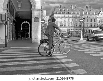 PARIS, FRANCE - JULY 11, 2006: Healthy businessman in suit makes city trip by bike on July 11, 2006 in Paris, France.