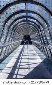 PARIS, FRANCE - JULY 11, 2022: Glass Dome Footbridge In La Defense, Paris During Daytime And Walking Business People In Motion Blur