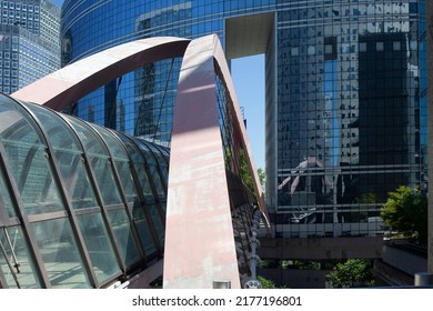 PARIS, FRANCE - JULY 11, 2022: Glass Dome Footbridge In La Defense, Paris During Daytime And Walking Business People In Motion Blur