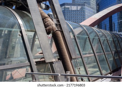 PARIS, FRANCE - JULY 11, 2022: Glass Dome Footbridge In La Defense, Paris During Daytime And Walking Business People In Motion Blur