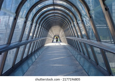 PARIS, FRANCE - JULY 11, 2022: Glass Dome Footbridge In La Defense, Paris During Daytime And Walking Business People In Motion Blur