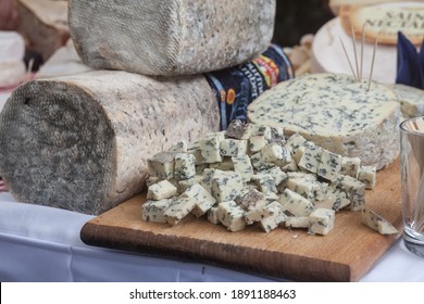 PARIS, FRANCE - JULY 12, 2019: Fourme D'Ambert Cheese Sliced On Display On A Table. Fourme Dambert Is A Typical Blue Cheese From The Auvergne Region Produced Around Ambert.

