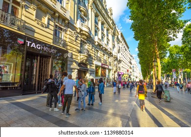 Paris, France - July 2, 2017: Tourists Walk On The Most Famous Avenue In Paris, The Champs Elysees, Known For Luxury And Shopping That Starts From Place De La Concorde To Place Charles De Gaulle.