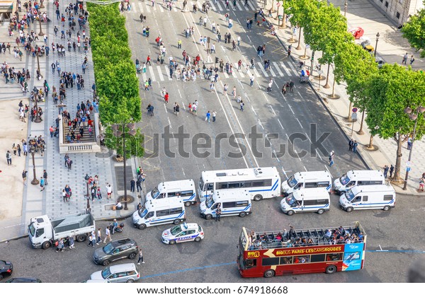 PARIS, FRANCE -\
JULY 2, 2017: French police gendarmerie, keeping security with\
checkpoints at Place Charles de Gaulle in Paris, for tourists at\
Arc de Triomphe with touristic\
bus.