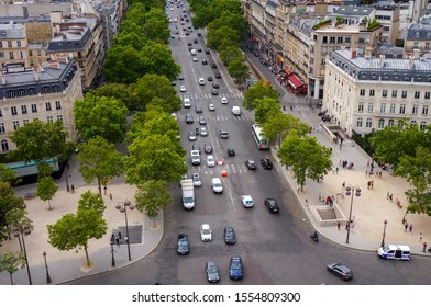 Paris, France - July 2019 - High Angle View Above The Tree-lined Avenue De La Grande Armée, With Car Traffic, People On Sidewalks And A National Police Car, Shot From The Top Of Arc De Triomphe