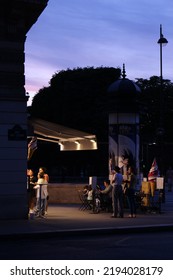 Paris, France - July 23, 2022: People Order And Enjoy Ice Cream Outside An Ice-cream Parlor At Dusk In Paris. 