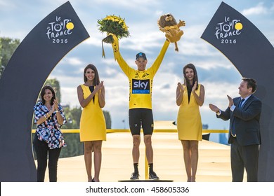 PARIS, FRANCE - JULY 24, 2016 : The road racing cyclist Christopher Froome winner of Tour de France 2016, wearing the leader's yellow jersey on the fist step of the podium celebrates his victory.