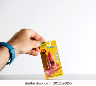 Paris, France - July 30, 2017: POV Male Hand Holding Kids Nail Polish In Pink Color Manufactured By Crayola