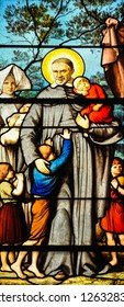 PARIS, FRANCE, JULY 7, 2013. Saint Vincent De Paul Gathering With The Daughters Of Charity Abandoned Children, Stained Glass Window In Saint Severin Church