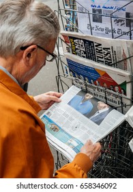 PARIS, FRANCE - JUN 12, 2017: Senior Man Buying At Press Kiosk UK Newspaper The Daily Telegraph With Theresa May Picture And Reactions To United Kingdom General Election Of 2017 