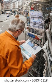 PARIS, FRANCE - JUN 12, 2017: Senior Man Buying At Press Kiosk UK Newspaper The Daily Telegraph With Theresa May Picture And Reactions To United Kingdom General Election Of 2017 