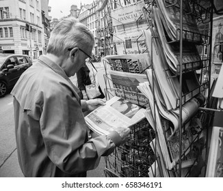 PARIS, FRANCE - JUN 12, 2017: Senior Man Buying At Press Kiosk UK Newspaper The Daily Telegraph With Theresa May Picture And Reactions To United Kingdom General Election Of 2017 