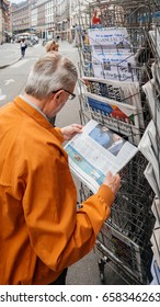 PARIS, FRANCE - JUN 12, 2017: Senior Man Buying At Press Kiosk UK Newspaper The Daily Telegraph With Theresa May Picture And Reactions To United Kingdom General Election Of 2017 