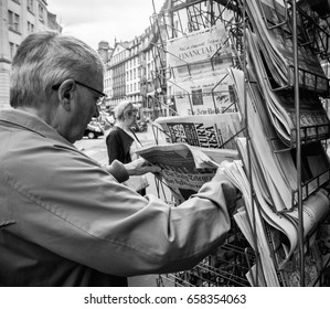 PARIS, FRANCE - JUN 12, 2017: Senior Man Buying At Press Kiosk UK Newspaper The Daily Telegraph With Theresa May Picture And Reactions To United Kingdom General Election Of 2017 