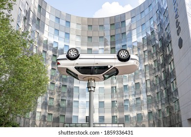 Paris, France - Jun 13, 2020: Flipped car as art display in front of Spaces building in la defense