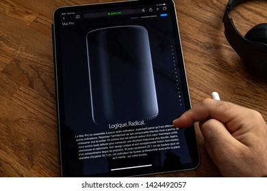 Paris, France - Jun 6, 2019: Man Reading On Apple IPad Pro Tablet About Powerful Professional Workstation Computer Mac Pro With Logic And Radical Text