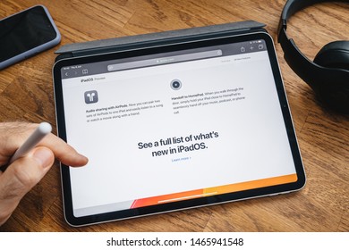 Paris, France - Jun 6, 2019: Man Reading On Apple IPad Pro Tablet About Latest Announcement Of Presenting IPadOS Preview Audio Sharing With Airpods Handoff To Homepod