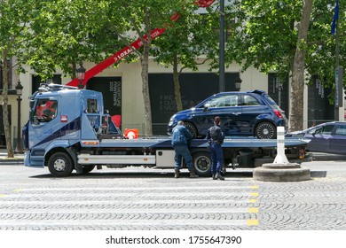 Paris, France. June 06. 2020. An in violation vehicle removed by a tow truck after being verbalized by the police. Impounded for illegal parking.