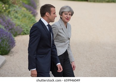 PARIS, FRANCE - JUNE 13, 2017 : The Prime Minister of United Kingdom Theresa May  walking with the french President Emmanuel Macron  in the gardens of Elysee Palace after a working visit.