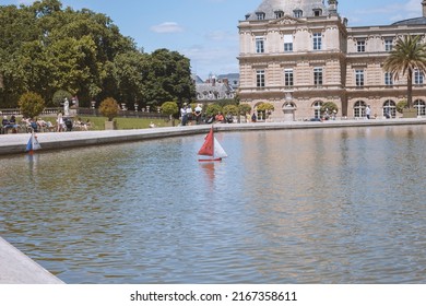 PARIS, FRANCE - JUNE 14, 2022: Children's boats in the fountain near the Luxembourg Palace in the Luxembourg Gardens Toy boats are the most popular attraction in the Luxembourg Gardens.
