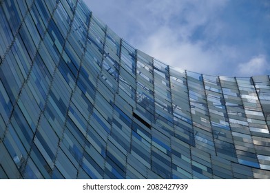 Paris, France - June 2021 - Low Angle View Taken Below The Curved, Blue Glass Facade Of The Futuristic Offices Of 