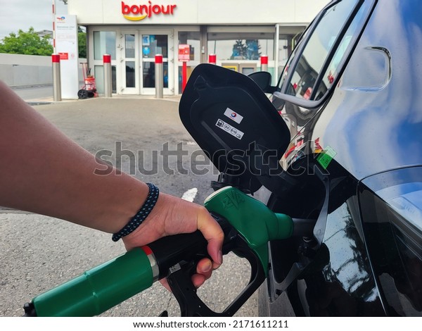 PARIS, FRANCE - JUNE 2022: Refueling a car with\
E10 super at a french gas\
station