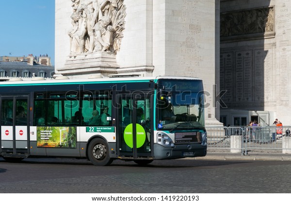 PARIS, FRANCE - JUNE 23, 2017:\
Green public bus near the Arc de Triomphe in center part of\
Paris.