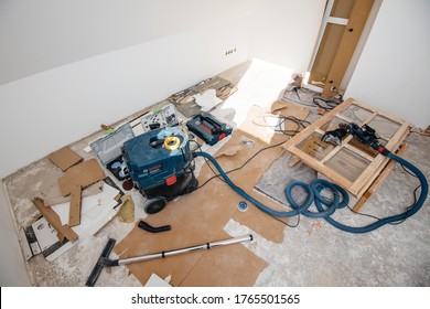 Paris, France - June 8, 2020: Overhead View Of Messy Floor In Large Room During Renovation With Bosch Gas 35 Vacuum Cleaner, Festool Rotex 90 Sanding Machine And Wooden Window