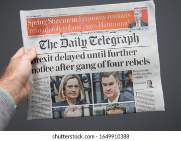 Paris, France - Mar 15, 2019: Male Hand POV At The Latest THe Daily Telegraph Edition Of Newspaper Featuring Breaking News About Delayed Brexit